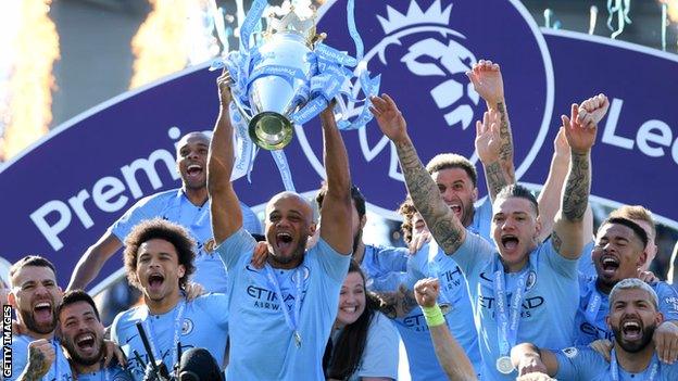 Manchester City captain Vincent Kompany holds up the Premier League trophy