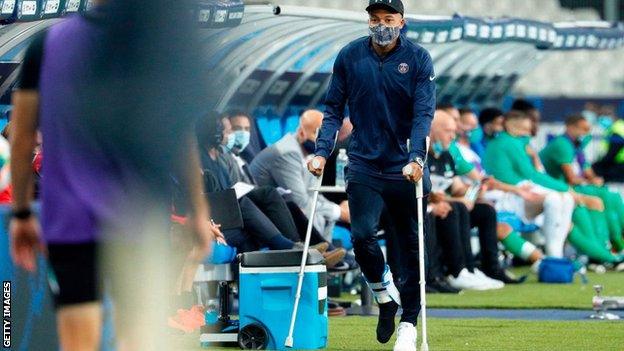 Kylian Mbappe on crutches