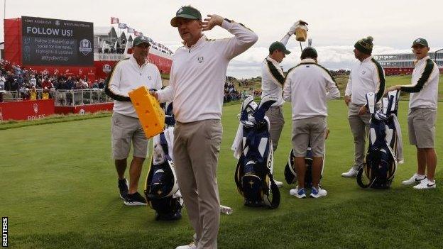 Ian Poulter gestures to the crowd on the first tee at Whistling Straits