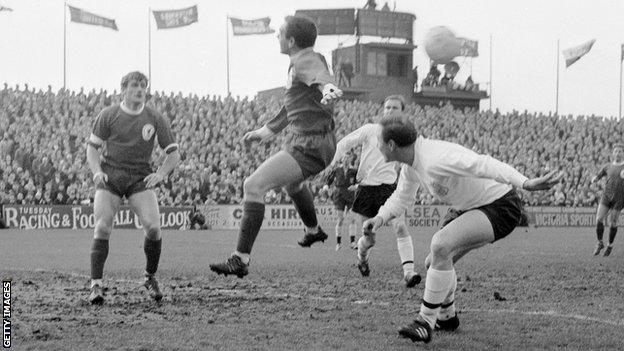 Ian St John goes for the ball