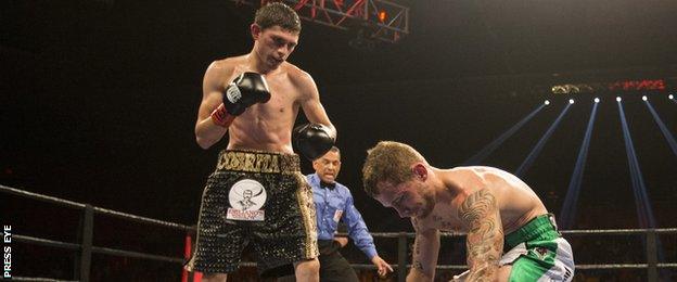 Carl Frampton drops to his knees after being put down in the first round of his title defence