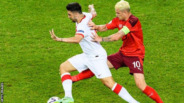 Ozan Tufan evades Switzerland's Granit Xhaka during Turkey's Euro 2020 Group A defeat in Baku