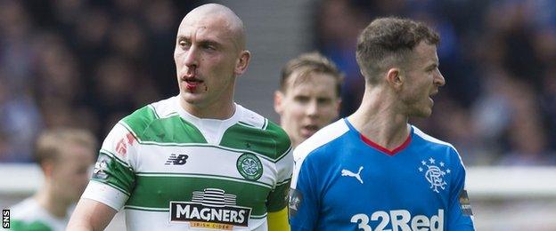 Celtic's Scott Brown (left) sports a bloody nose against Rangers