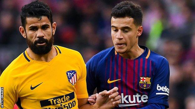 Barcelona's Philippe Coutinho battles with Atletico Madrid's Diego Costa