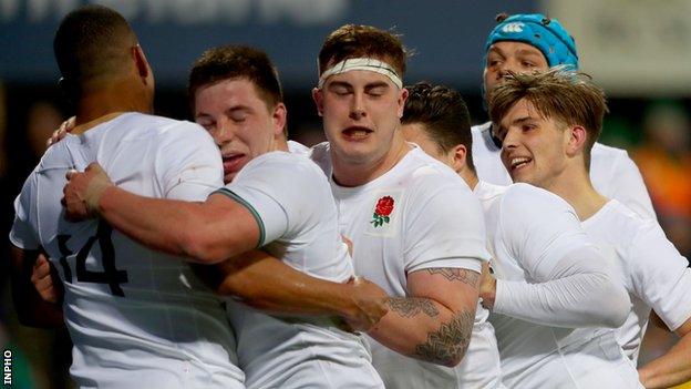 Henry Walker is congratulated by England team-mates after scoring his side's second try