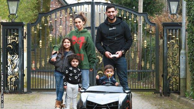 Faryal Makhdoom, Amir Khan and three children outside their home in Bolton.