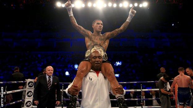 Nigel Benn hoists his son Conor onto his shoulders after his win