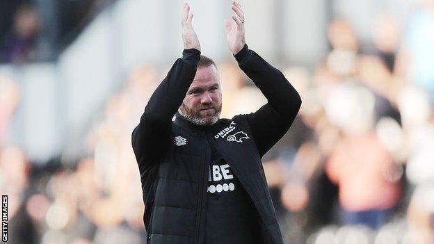 Derby boss Wayne Rooney applauds supporters