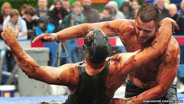 men wrestle in gravy