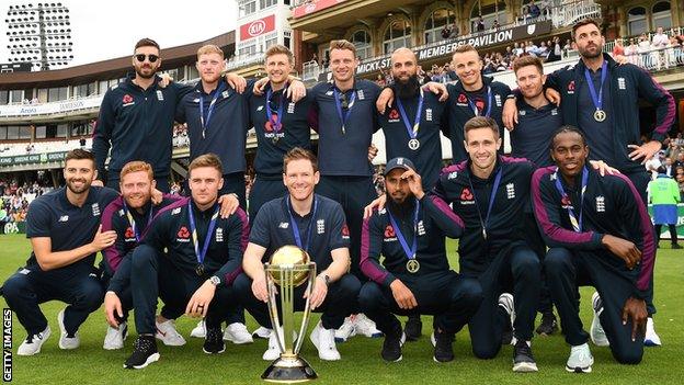 England's World Cup squad pose with the trophy