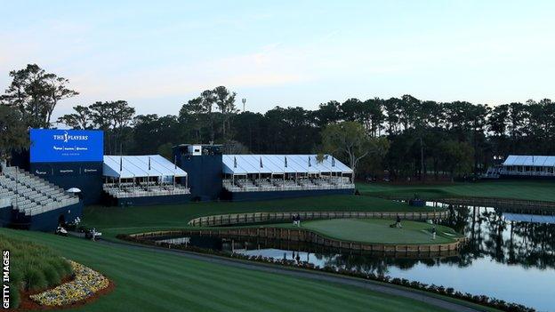 The 17th green at TPC Sawgrass with empty stands in the background