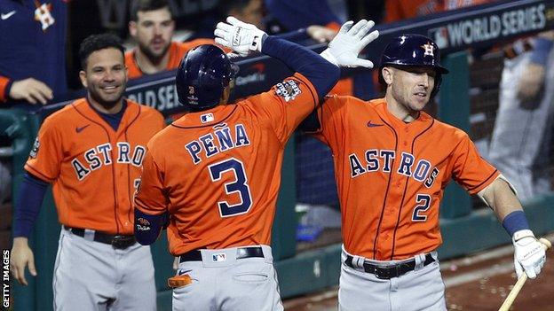 Jose Altuve, Jeremy Pena and Alex Bregman celebrate Pena's home run in the fourth inning