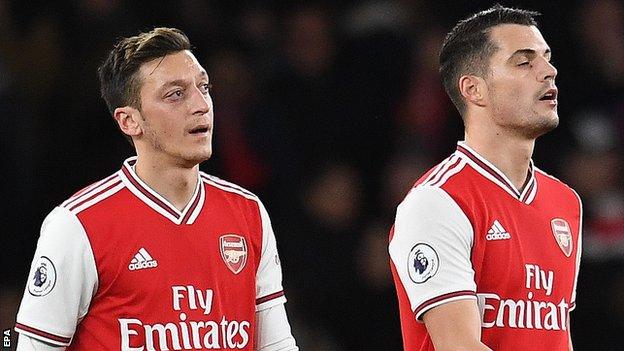 Arsenal players react after conceding a goal during the English Premier League soccer match Arsenal v Brighton