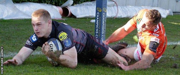 Johnny McNicholl puffs out his cheeks as he dives over for Scarlets' first try in Treviso