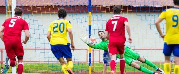 Joe Lewis saves a penalty