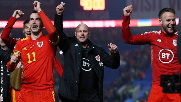 Robert Page (centre) celebrates with Gareth Bale (left) and Chris Gunter