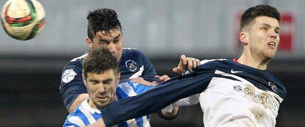 Coleraine's Steven Douglas goes for a high ball against Emmett Friars and Adam Leckey of Ballinamallard