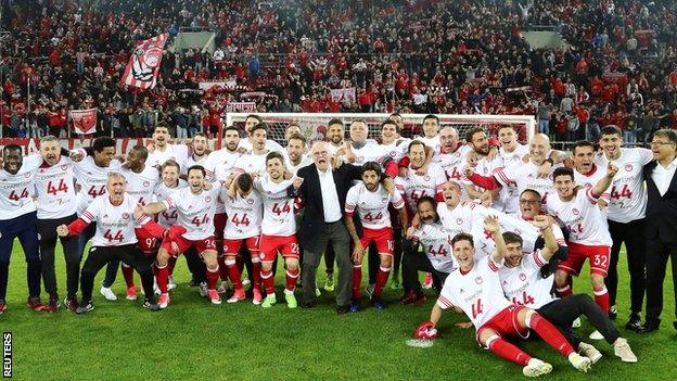 Olympiakos players and supporters celebrate winning the 2016-17 Greek Super League title