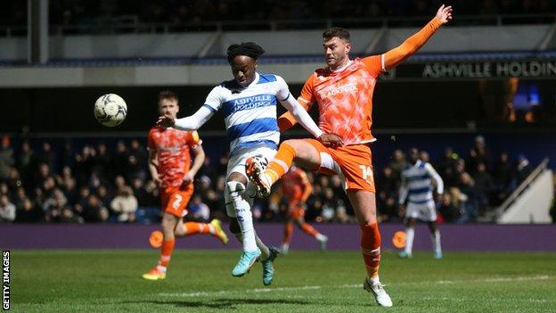 Blackpool's Gary Madine and Queens Park Rangers' Moses Odubajo