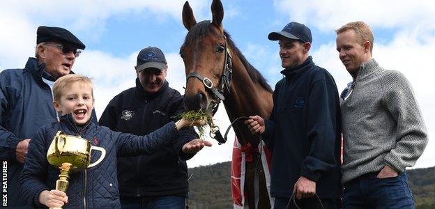 2016 Melbourne Cup Winner Almandin with (left to right) owner Lloyd Williams, trainer Rob Hickmott, Joel Flannery and Australian Jockey Kerrin Mcevoy with Lloyd's grandson Frank Williams holding the Melbourne Cup