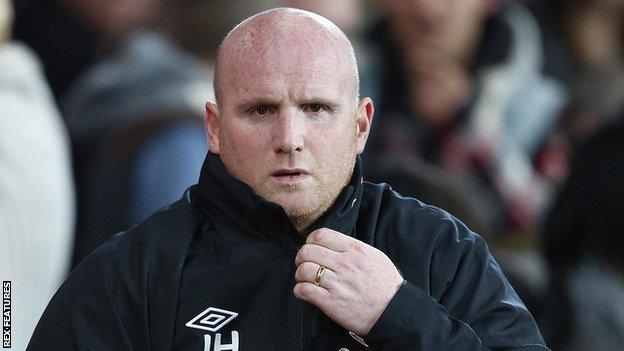 John Hartson keeps warm