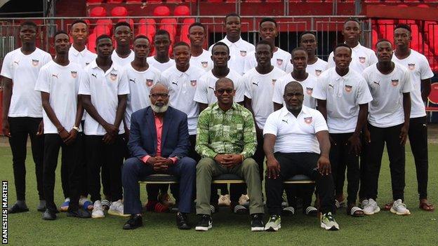 Liberia's Under-17 squad, with Liberia Football Association pair Ivan Brown and Mustapha Raji in the front row with coach Ansu Keita