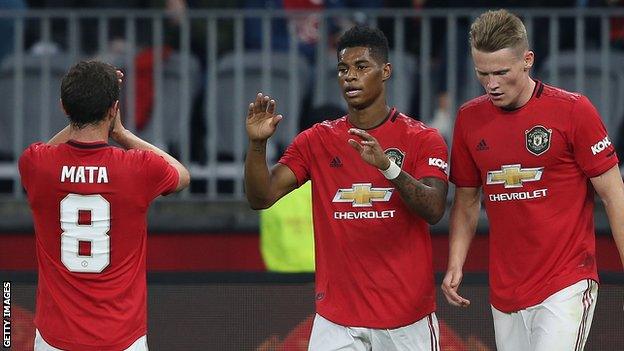 Marcus Rashford (centre) celebrates