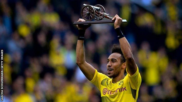 Dortmund's Gabonese forward Pierre-Emerick Aubameyang lifts the trophy as the Bundesliga's top-scorer