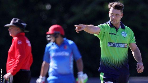 Ireland's Curtis Campher makes some adjustments to the field during Friday's game with Afghanistan at Stormont