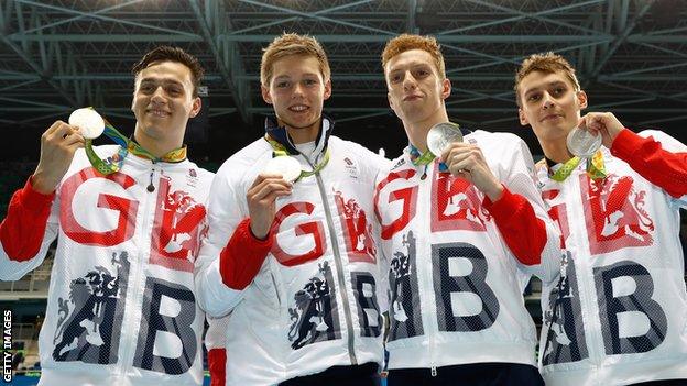 James Guy, Duncan Scott, Daniel Wallace and Stephen Milne of Great Britain pose on the podium during the medal presentation for the Men's 4 x 200m Freestyle