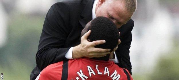 Yves Ma-Kalambay is kissed by his Hibernian manager John Hughes