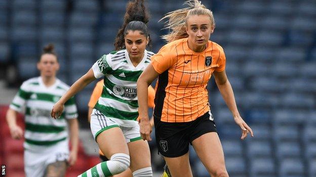 Glasgow City's Lauren Davidson (R) runs past Celtic's Jacynta Galabadaarachchi during a Women's Scottish Cup Semi-Final between Glasgow City and Celtic at Hampden Park