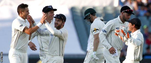 Trent Boult (left) celebrates a wicket with team-mates