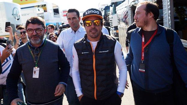 Fernando Alonso visits the McLaren garage during pre-season testing in Barcelona