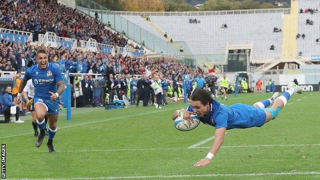 Italy's Ange Capuozzo of Italy scores a try against Australia