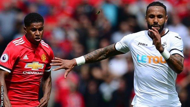 Kyle Bartley (right) challenges Marcus Rashford