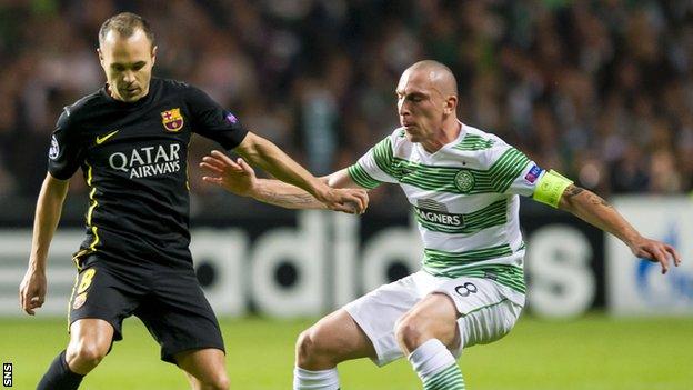 Celtic's Scott Brown closes down Andres Iniesta of Barcelona during their Champions League match in Glasgow in October 2013