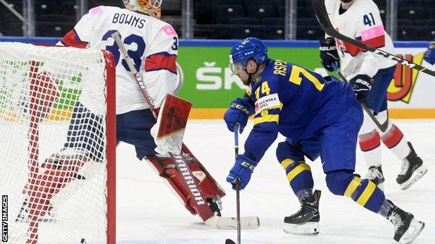 Sweden's Rasmus Asplund scores against Great Britain at the Ice Hockey World Championship