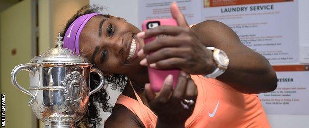 Serena Williams poses for a selfie with the Suzanne Lenglen trophy after winning this year's French Open