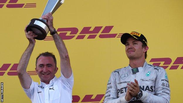 Mercedes co-team boss Paddy Lowe (L) and Mercedes' German driver Nico Rosberg celebrate on the podium after winning the constructors title in the inaugural Russian Formula 1 Grand Prix at the Sochi Autodrom in Sochi on October 12, 2014