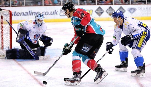 Coventry goalkeeper Brian Stewart tries to keep out Michael Forney of the Belfast Giants