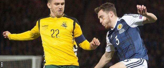 Andrew Robertson takes on the Lithuania defence