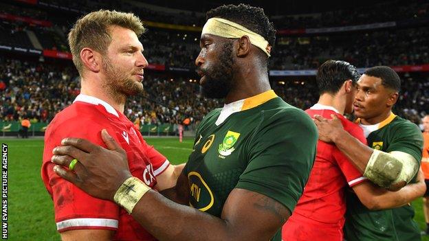 Opposing captains Dan Biggar and Siya Kolisi embrace after the game