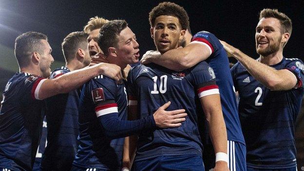 Che Adams (centre) and Scotland players celebrate against Denmark