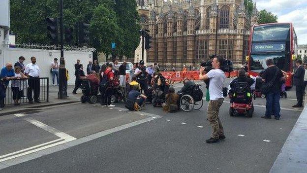 Protesters block the road outside Parliament