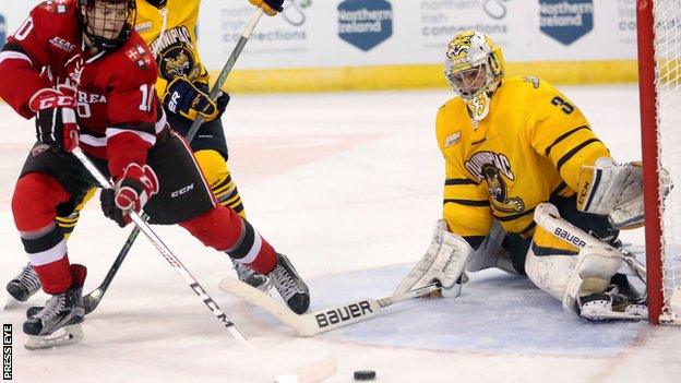 Chris Truehl keeps out St. Lawrence Saints' Ryan Lough while playing for the Quinnipiac Bobcats at the Friendship Four in Belfast