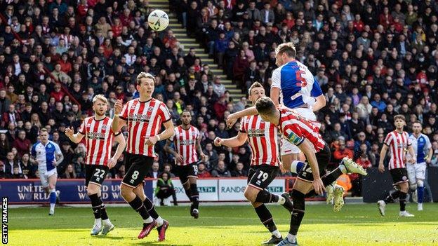 Dominic Hyam of Blackburn leaps to head the ball against Sheffield United