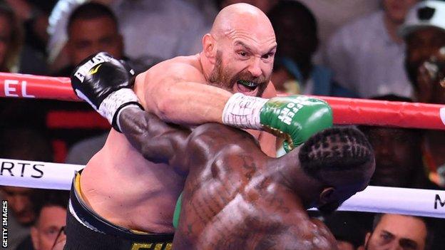 Tyson Fury punches Deontay Wilder