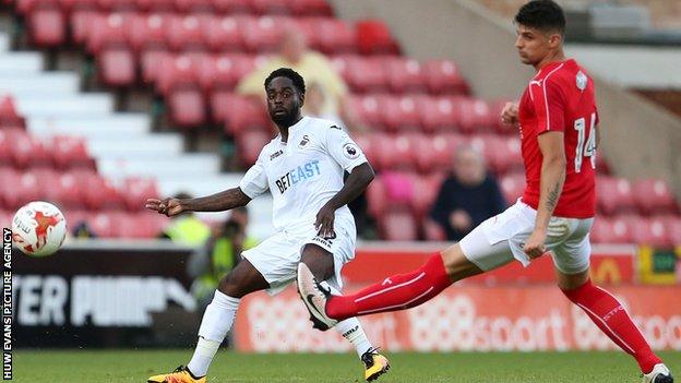 Nathan Dyer crosses the ball for Swansea City against Swindon Town