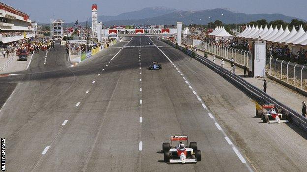 Alain Prost drives past the retired car of team-mate Ayrton Senna during the French Grand Prix on 9 July 1989 at Le Castellet